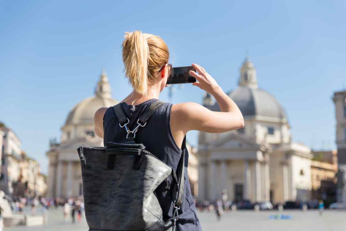 Una turista scatta foto in uno dei posti di Roma più visitati dai turisti stranieri